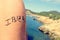 Young man with the word Ibiza written in his arm