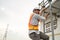 Young man worker or engineer climb ladder.