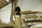 A young man working as carpenter in his wood workshop. Wood worker designing and handcrafting new house furniture using a piece of