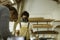 A young man working as carpenter in his wood workshop. Wood worker designing and handcrafting new house furniture using a piece of