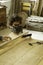 A young man working as carpenter in his wood workshop. Wood worker designing and handcrafting new house furniture using a piece of