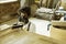 A young man working as carpenter in his wood workshop. Wood worker designing and handcrafting new house furniture using a piece of