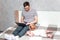 Young man working on a laptop in bed at home and baby beside. Concept Working remotely