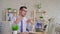 Young man working on a laptop in the office sitting in front of the fan slow mo