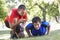 Young Man Working With Personal Trainer In Park