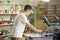 Young man working with squeegee on factory