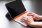 Young man is working on a white orange convertible laptop