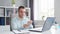 Young Man Works while Sitting in front of a Computer at Home. The Workplace of a Professional Worker, Freelancer or