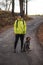 young man in a yellow jacket aged 20-24 on a walk with a Czech mustache  a hunting dog. Binary portrait of taking care of pet