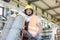 Young manual worker moving gas cylinders in metal industry