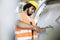 Young manual worker tightening bolts on machinery in factory