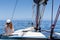 Young marine style woman is sitting on the boat and looking forward