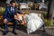 Young married couple on a bench, smiling happy. Lake Garda, Torri del Benaco, Italy.