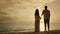 Young married couple holding hands, facing the sea and sunset. Happy Honeymoon