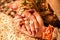 Young married couple holding hands, indian ceremony wedding day