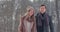 Young married couple in love walking in the winter forest. A man and a woman look at each other laughing and smiling in