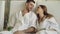 Young married couple is relaxing sitting in modern spa salon with cocktail glasses, chatting and kissing. Romantic