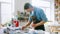 Young master in an apron at work in his workshop. Working man with mosaic