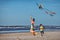 Young mather and her son playing with kite