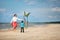 Young mather and her son playing with kite