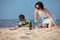 Young mather and son playing on the beach