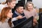 Young and mature business people grouped around computer monitor