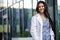 Young medical professional at her new career job, standing portrait in a white coat