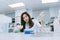 Young medical scientist working in medical laboratory , young female scientist using auto pipette to transfer sample