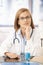 Young medical student sitting at desk in office