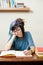 Young meditating teen female student with book