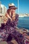 Young mediterranean woman sitting at harbour dock