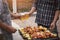 Young men cheers for a drink at a BBQ party between friends. Food, drink, people and family time concept