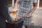 Young men cheers for a drink at a BBQ party between friends. Food, drink, people and family time concept