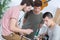 Young men composing music one playing guitar