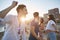 Young men dancing with their girlfriends on beach