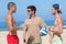 Young men in discussion on beach