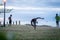 Young men exercising martial arts on beach