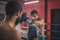 Young men fighting on a boxing ring and looking determined