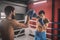 Young men fighting on a boxing ring and looking determined