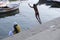 Young men Jumping & swimming in holy Ganga River, Varanasi, Uttar Pradesh, India
