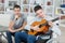 Young men playing guitar and singing