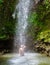 Young men relaxing at Toraille waterfall St Lucia. Saint Lucia jungle waterfall and men swimming