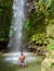 Young men relaxing at Toraille waterfall St Lucia. Saint Lucia jungle waterfall and men swimming