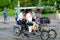 Young men riding velomobile.