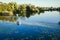 Young men rowing kayak on river at sunset. Couple of friends having fun canoeing in summer