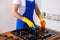 Young Men in rubber protective cleaning and polish cooker. Black