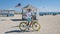 Young men in a swim short on the beach Miami with a bicycle, colorful Miami beach Florida