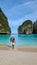 young men with swimshort and hat on the beach of Maya Bay Koh Phi Phi Thailand