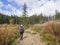 Young men tourist hiking at the beautiful nature trail at high tatra mountains in slovakia, late summer sunny day