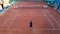 Young men training tennis on the clay court. high angle view